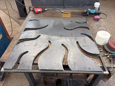 The plasma cut sheet is placed over the frame